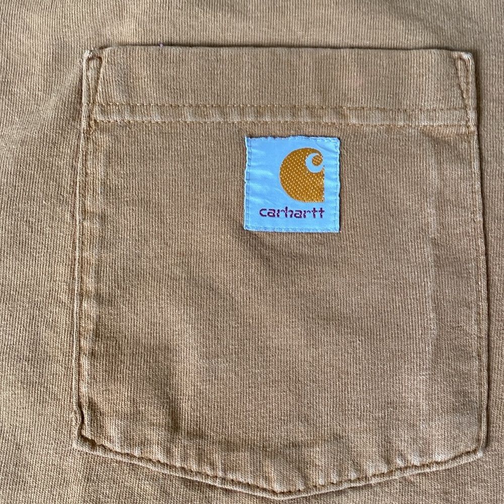 Vintage Carhartt shirt in their iconic orange-brown color with minor worn sings